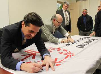 Amherstburg Mayor Aldo DiCarlo and Deputy Mayor Bart Dipasquale sign the Special Olympics Flag, January 4, 2016. (Photo by Maureen Revait) 