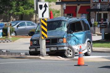 A van sits along Huron Church Rd. N. at Malden Rd. after being hit by a school bus, August 11, 2015. (Photo by Mike Vlasveld)