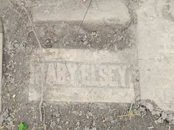 A Confederation-era tombstone uncovered by Western students at Woodland Cemetery. (Photo by Miranda Chant, Blackburn News)