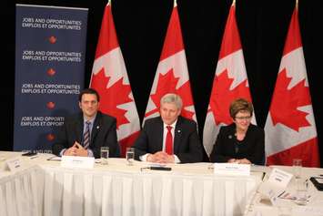 Essex MP Jeff Watson, left, Prime Minister Stephen Harper and Minister of Public Works and Governmental Services Diane Finley talk about auto manufacturing in Windsor, May 13, 2015. (Photo by Jason Viau)