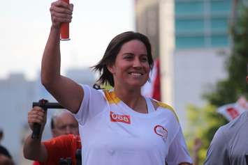 Olympic boxer Mary Spencer carries the flame during the Pan Am Torch Relay in Windsor, June 16, 2015. (Photo by Jason Viau)