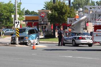 A van sits along Huron Church Rd. N. at Malden Rd. after being hit by a school bus, August 11, 2015. (Photo by Mike Vlasveld)