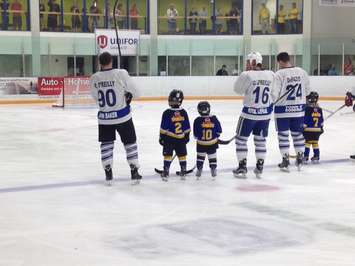 Ryan (far left) and Cal O'Reilly stand during 