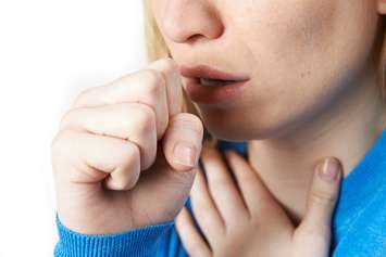 File photo of woman coughing. Photo courtesy of © Can Stock Photo / HighwayStarz