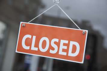 A closed sign hangs in a retail store window. File photo courtesy of © Can Stock Photo / kevers
