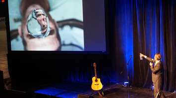 Chris Hadfield shares experience handling water without gravity in space, while addressing students in Sarnia. May 25, 2016 (BlackburnNews.com Photo by Briana Carnegie)