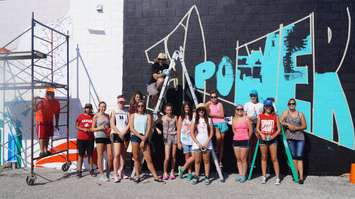 Students work on mural on the side of Kwik Kopy on Exmouth St. August , 2016 BlackburnNews.com photo by Jake Jeffrey