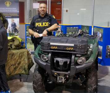 OPP Constable Travis Parsons standing next to an ATV (photo by Jake Jeffrey)