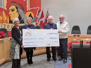A cheque for the Community Support Centre of Essex County is displayed by, from left, Diana Lausch, Board Member of the CSC; Tracey Bailey, Lakeshore Mayor and Executive Director of the CSC; Lakeshore Deputy Mayor Kirk Walsted, and Tecumseh Mayor Gary McNamara, at Tecumseh Council Chambers, November 30, 2023. Submitted photo.