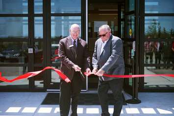 Lambton Shores Mayor Doug Cook (L) and former Mayor Bill Weber (R) cut the ribbon on the new Lambton Shores municipal administration building - May 25/23 (Photo courtesy of Alex Boughen)