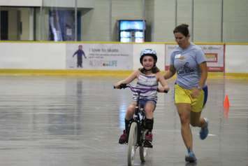 Addison riding her first two-wheel bike at the iCan Bike Camp in Chatham. July 13, 2016. (Photo by Natalia Vega)
