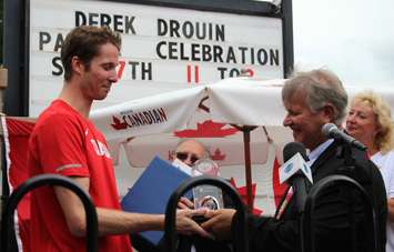 St. Clair Township Mayor Steve Arnold makes presentation to Derek Drouin at Olympic homecoming in Corunna Aug. 27, 2016 (BlackburnNews.com photo by Dave Dentinger)