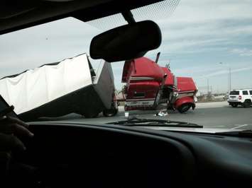 A tractor trailer flips over at the roundabout at Hwy. 3 and Hwy. 401, April 14, 2015. (Photo courtesy of Susan Hill-Jamieson)