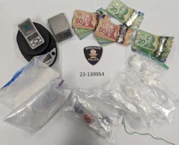 A quantity of confiscated drugs and cash is displayed by Windsor police on December 6, 2023. Photo provided by Windsor police.
