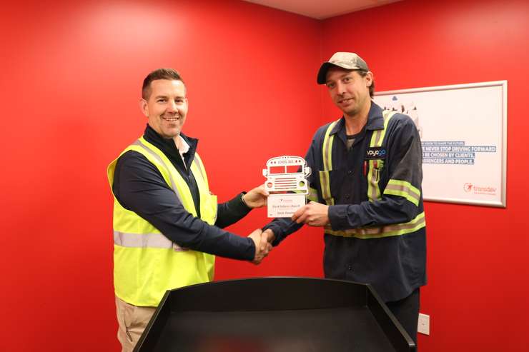 Travis Kelly presenting award to Zack Dowler. Photo provided by Chuck Archer, Voyago Vice President of Marketing and Communications.