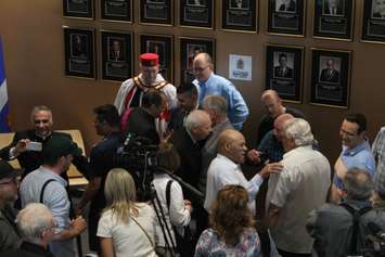 Windsor Mayor Drew Dilkens (in blue shirt) and former mayor Eddie Francis gather with current and former politicians at the new Windsor City Hall, May 26, 2018. Photo by Mark Brown/Blackburn News.