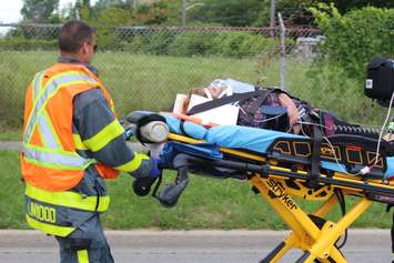 EMS crews tend to a number of people after a crash between a car and minivan at St. Luke Rd. and Richmond St., July 31, 2015. (Photo by Mike Vlasveld)