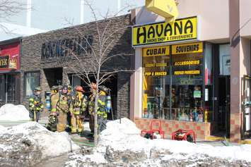 Windsor firefighters respond to a blaze at Havana Smoke Shop & Convenience in the 500-block of Ouellette Ave. downtown, February 23, 2015. (Photo by Mike Vlasveld)