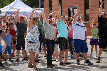 Mayor Darrin Canniff and councilors Trevor Thompson, Anthony Ceccacci and Mary Clare Latimer take part in the cherry pit spit at Cherry Fest in Blenheim on July 20, 2019. (Photo via Andrew Tompsett
Twitter)