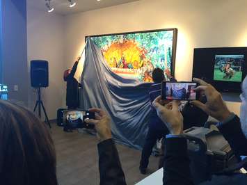 Aamjiwnaang Chief Joanne Rogers helps artist John Williams unveil his painting titled 