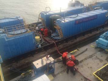 Crews continue operations for the Lake Erie sunken tanker barge Argo as Unified Command responders took advantage of a favorable weather window, Nov. 29, 2015. As weather allows, responders continued salvage operations hot-tapping and pumping the barge's tanks. (U.S. Coast Guard photo courtesy of Kurt Kollar, Ohio EPA)