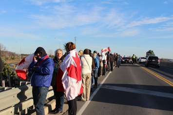 Supporters come out to the Communications Rd. overpass on Hwy. 401 for the repatriation ceremony of fallen veteran and Wheatley native John Gallagher on November 20, 2015. (Photo by Ricardo Veneza)