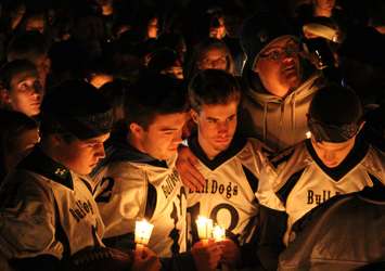 Teammates, friends and family of Michael Matte gather outside of General Amherst High School for a candlelight vigil, November 10, 2014. (photo by Mike Vlasveld)