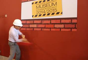 Windsor Mayor Eddie Francis takes a swing at a wall to kick off the museum expansion project at 401 Riverside Dr. West. (Photo by Maureen Revait) 
