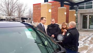 Strathroy-Caradoc Cst. Mark Thuss (right) and Deputy Chief Paul Landers explain the function of the service's new surveillance equipment to Lambton-Kent-Middlesex MPP Monte McNaughton and Strathroy-Caradoc Mayor Joanne Vanderheyden. January 18, 2019. (Photo by Colin Gowdy, BlackburnNews)