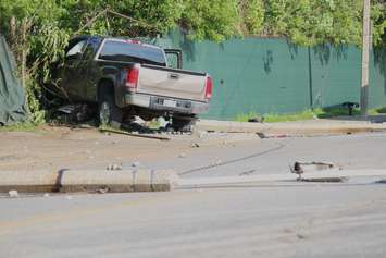 A truck knocks down two hydro poles and smashes through a fence on Drouillard just north of Franklin St., June 10, 2015. (Photo by Jason Viau)