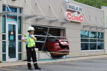 Emergency crews respond to a walk-in clinic on Tecumseh Rd. E after a car smashes through the front window, June 8, 2015. (Photo by Jason Viau)