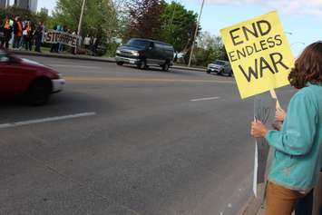 Protesters gather outside the Waterfront Hotel in downtown Windsor during Prime Minister Stephen Harper's visit to the city, May 13, 2015. (Photo by Jason Viau)