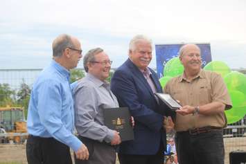 From left, Randall Sasso of the Ontario Trillium Foundation; Bill Kell, co-chair of the Farrow Riverside Miracle Park steering committee; Windsor-Tecumseh MPP Percy Hatfield; and Rick Farrow, committee co-chair, present a plaque for the Miracle Park in Windsor, May 24, 2019. Photo by Mark Brown/Blackburn News.