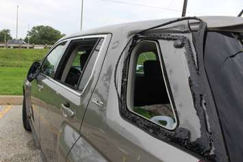 A heavily damaged vehicle sits near the EC Row Expressway and Central Avenue in Windsor on August 25, 2016 after a tornado ripped through the area, causing heavy damage. (Photo by Ricardo Veneza)
