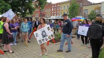 Mother who lost daughter to suicide holds sign in her memory during rally at Museum Square, June 7, 2016. Photo by Miranda Chant, Blackburn News) 