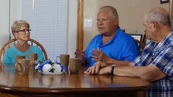 Ontario PC Leader Doug Ford speaking with Linda and Bill Reid at their farm in Plympton-Wyoming. May 30, 2018. (Photo by Colin Gowdy, BlackburnNews)