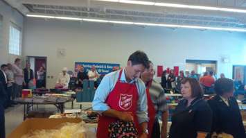 Prime Minister Trudeau helps load up a back pack for a child at Goderich's Salvation Army branch. August 25th, 2017 (Photo by Bob Montgomery)