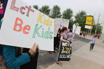 Parents and students hold a sex-ed protest outside NDP Windsor-West MPP Lisa Gretzky's office, June 5, 2015. (Photo by Jason Viau)