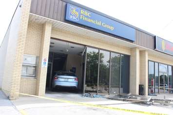 Three people were sent to hospital after a car smashes through the front of an RBC Bank on Huron Church Rd., July 3, 2015. (Photo by Jason Viau)