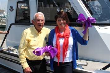 Lisa Clark and Art Speed displaying purple ribbons at Sarnia Bay Marina (Photo by Terry Easterby)
