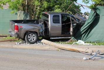 A truck knocks down two hydro poles and smashes through a fence on Drouillard just north of Franklin St., June 10, 2015. (Photo by Jason Viau)