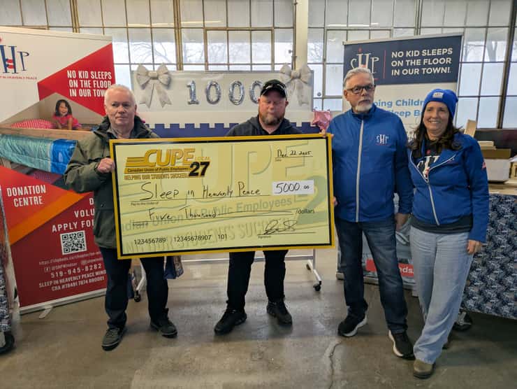 Members of CUPE 27 present a $5,000 cheque to Brian and Terry Cyncora of Sleep in Heavenly Peace in Windsor, December 22, 2025. Photo by Mark Brown/WindsorNewsToday.ca.