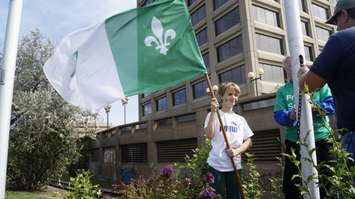 A student holds a Franco-Ontarian flag at the Seaway Parkette in Sarnia. September 25, 2019. (BlackburnNews photo by Colin Gowdy)