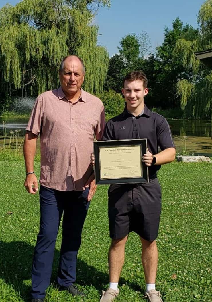 Tyson Lozon is awarded with the A.W. Campbell Memorial Scholarship by St. Clair Region Conservation Authority Chair Greg Grimes. July 2026. (Photo courtesy of the SCRCA)