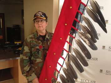 A woman stands during a signing ceremony at St.Clair College, September 22, 2015.  (Photo by Adelle Loiselle)