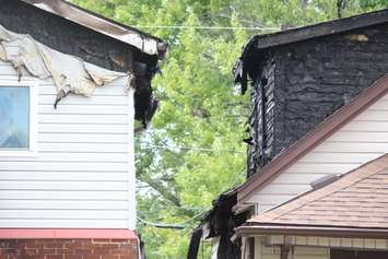 Police and fire officials investigate a fatal fire on Aubin Rd., August 12, 2015. (Photo by Jason Viau)