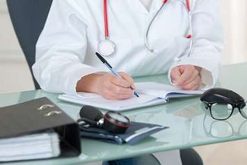 A doctor writing notes. File photo courtesy of © Can Stock Photo / photography33.