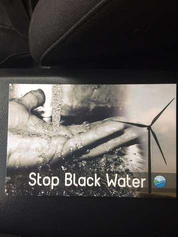 Info pamphlets being handed out by Water Wells First. June 22, 2017.  (Photo by Paul Pedro)