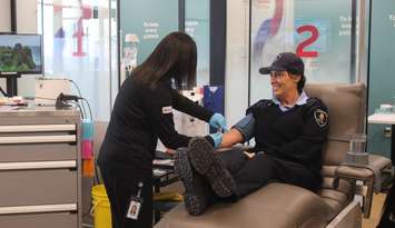 A Windsor Police Auxiliary officer donates plasma at the Plasma Donation Centre in Windsor, February 28, 2024. (Photo by Maureen Revait) 