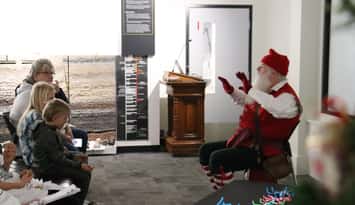 Families listen to holiday stories from Victorian Santa at the Oil Museum of Canada. Submitted photo.